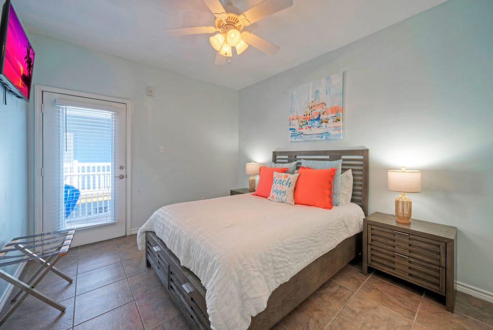 Bedroom 2 features a queen bed, TV, and an ensuite bathroom. (203)