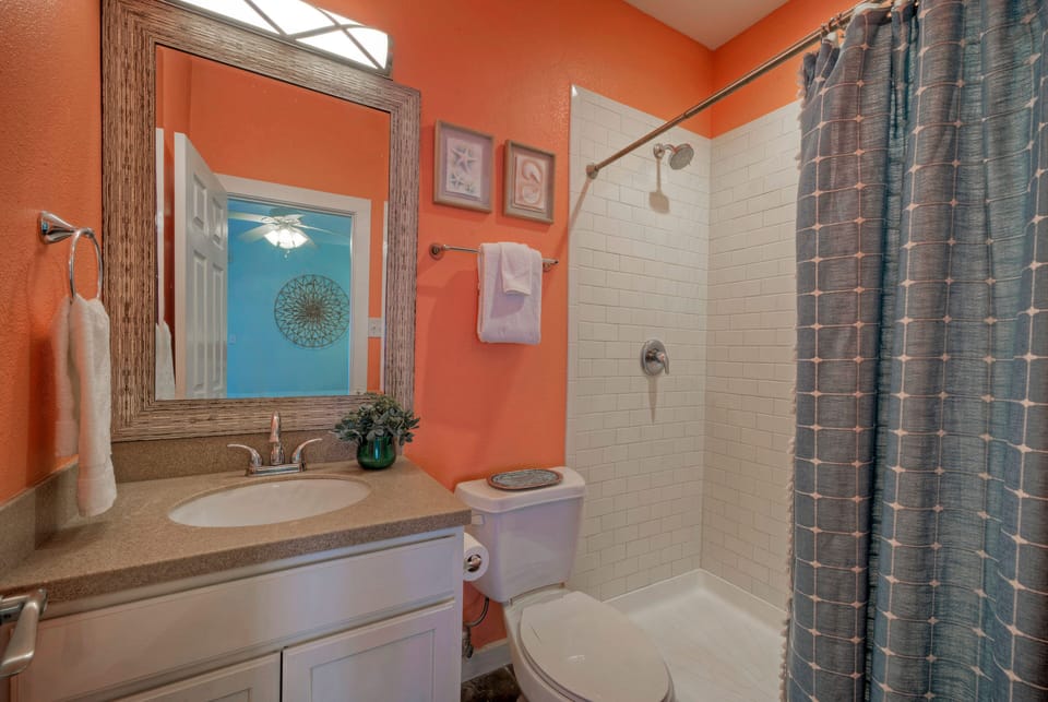 A bright full bathroom with a spacious walk-in shower.