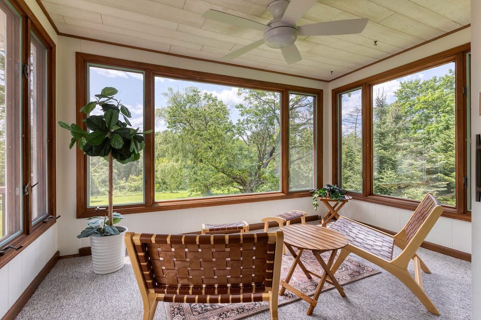 Step out onto the sun-drenched porch, a perfect spot to unwind with a book or simply enjoy the tranquility. 