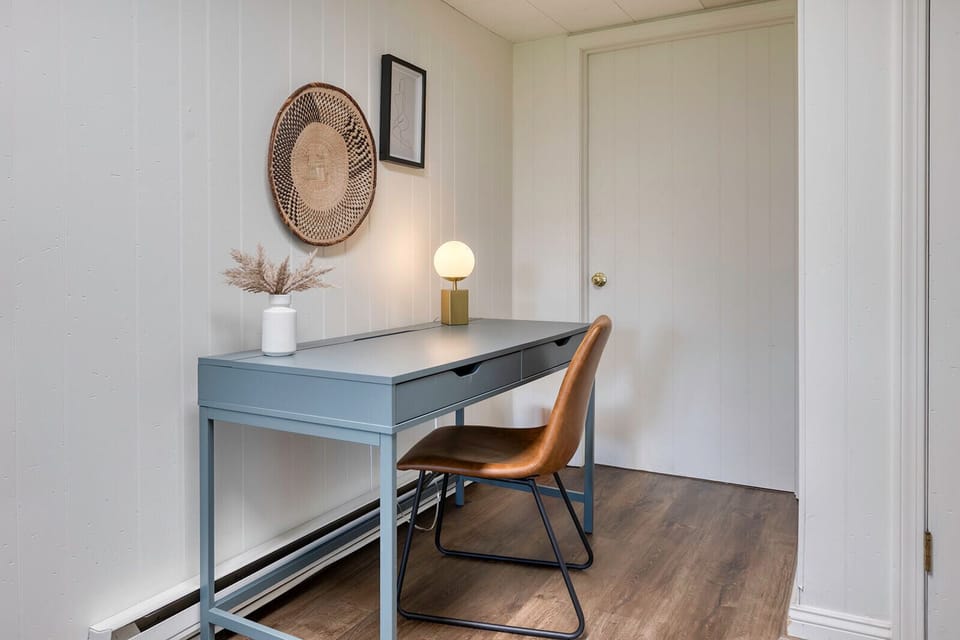A dedicated work-from-home space is located in the basement, set off to the side in a quiet area.