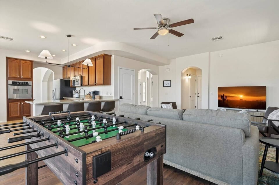 Enjoy a lively game of foosball or unwind with your favorite show in the stylish family room, 