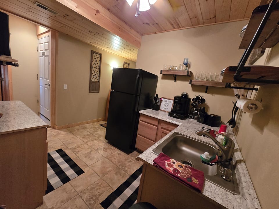 coffee and or coffee maker, kitchenette, refrigerator
