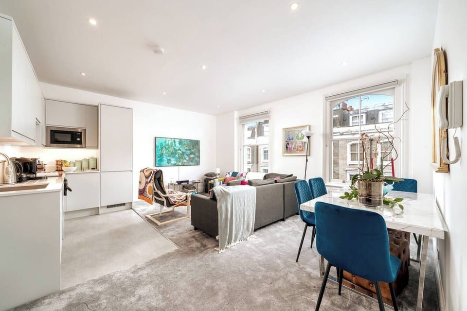 Step into this cozy and well-arranged living room, featuring a comfortable couch that invites relaxation. The couch is adorned with soft pillows, setting the stage for a perfect entertainment area.