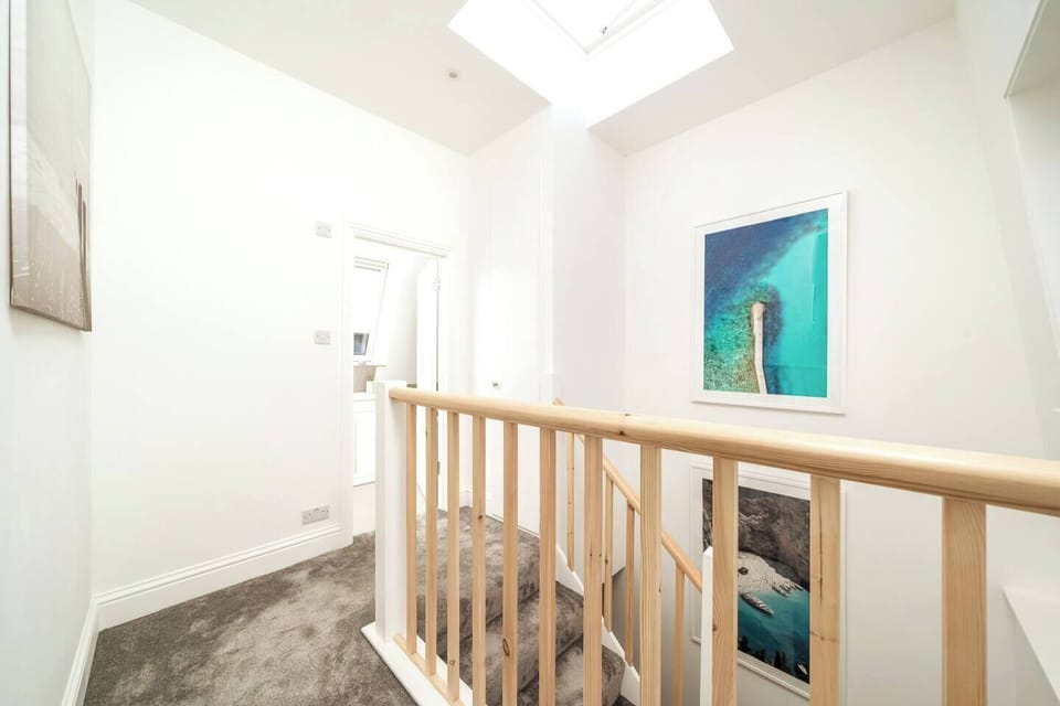 A perfect stairway just like in the movies adorned with artworks with a cinematic touch of both elegance and  ambience.