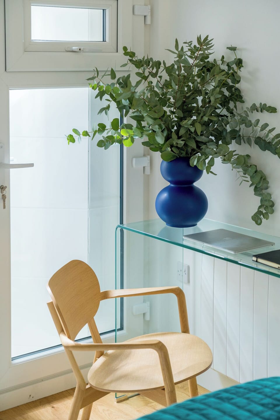 Enjoy a dedicated workspace with a sleek glass desk and a comfortable chair, perfect for remote work or journaling.