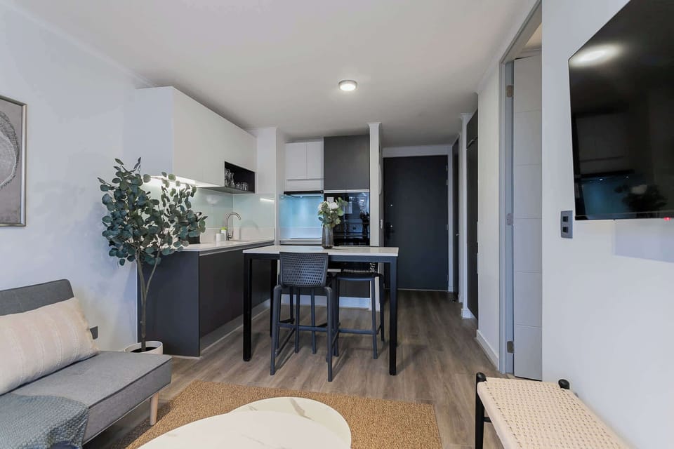 Chic and modern studio kitchen with cozy seating, perfect for a relaxing stay in the heart of Chile.