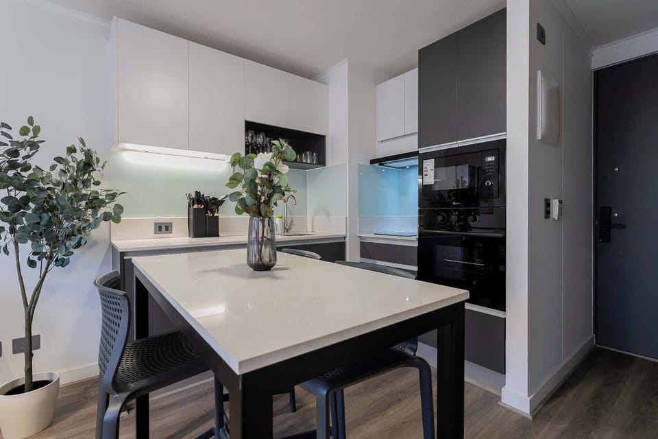 Sleek and modern kitchen with dining space, perfect for enjoying meals in style.