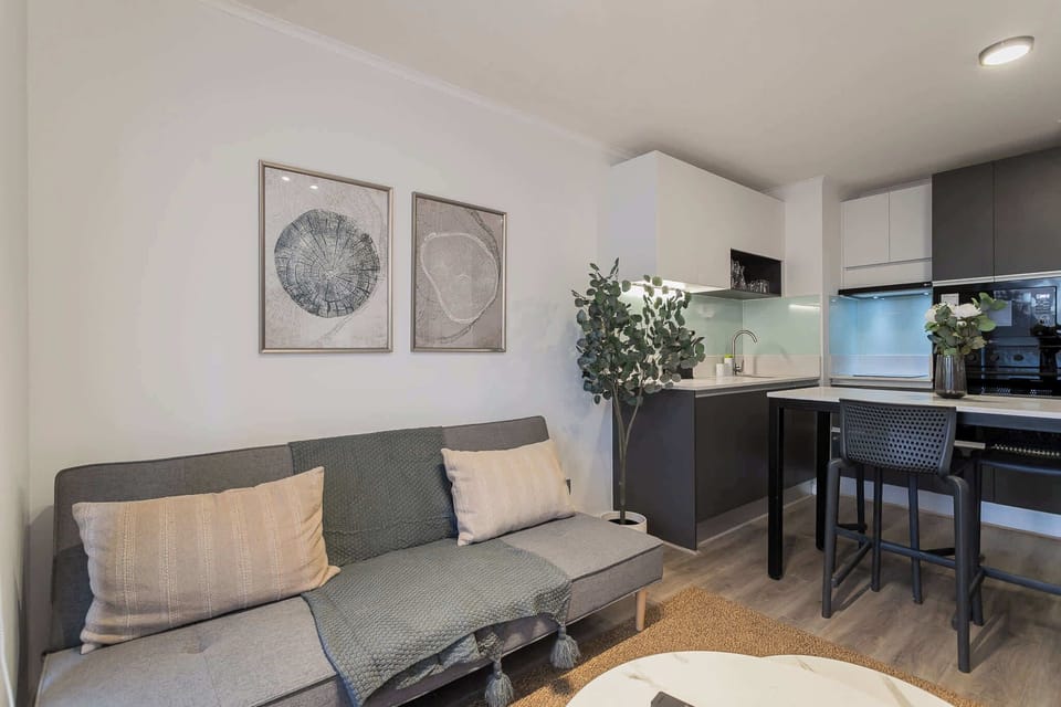 Cozy and modern living area with sleek kitchen and stylish decor, perfect for a relaxing stay.