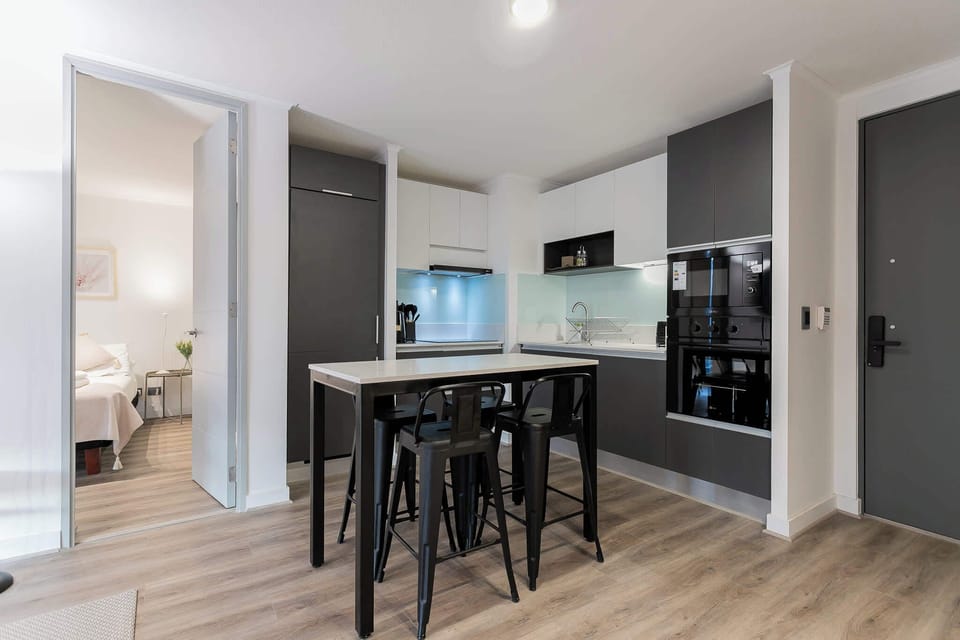 Experience modern living in this sleek kitchen with high-top dining, perfect for intimate meals or casual gatherings.