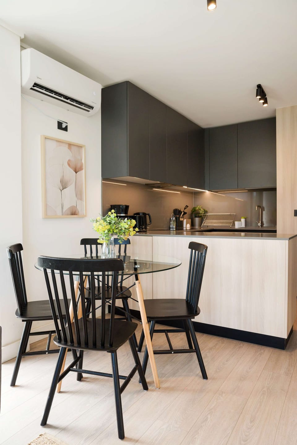 Stylish kitchen with modern cabinetry and a cozy dining area, perfect for intimate meals.