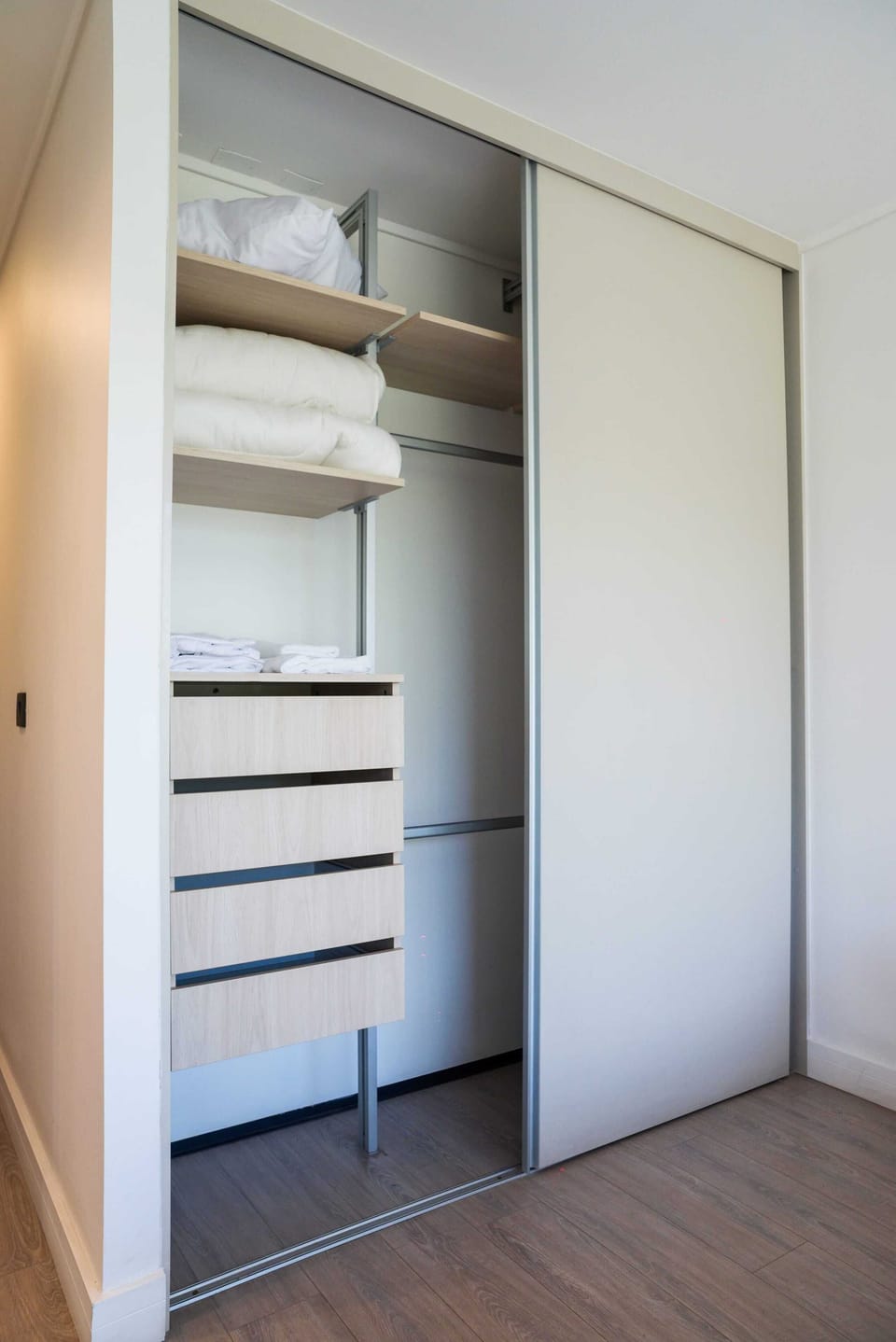 Organized closet with ample storage and fresh linens, perfect for a clutter-free stay.