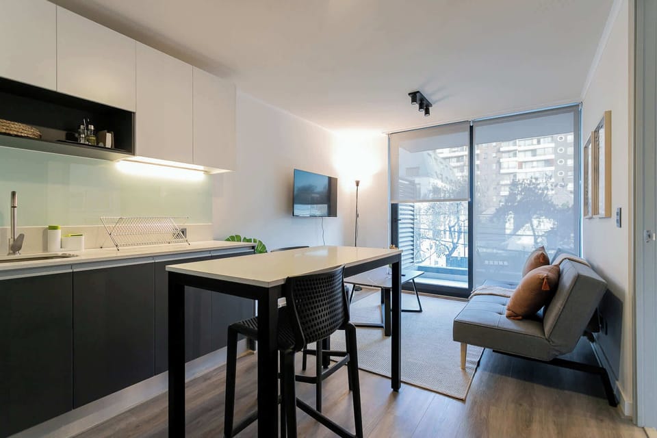 Chic studio with modern kitchen and cozy living area, perfect for a relaxing stay in the heart of the city.