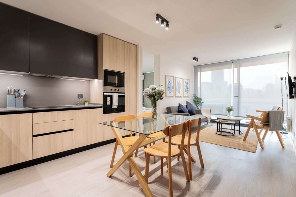 Experience modern comfort in this stylish living space, featuring a sleek kitchen and cozy seating, perfect for relaxation after a day of adventure.