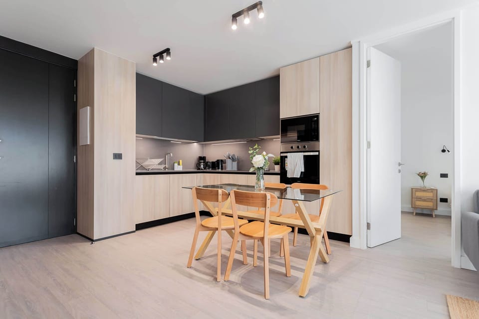 Sleek and modern kitchen with stylish dining area, perfect for enjoying meals in a cozy setting.
