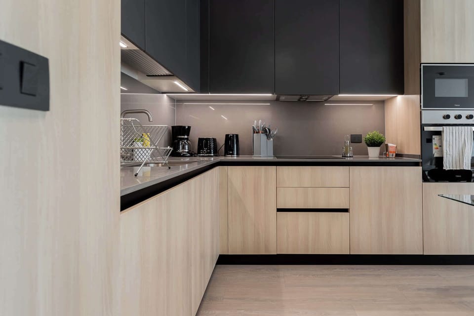 Sleek and modern kitchen with all essentials for a comfortable stay, perfect for cooking and dining in style.