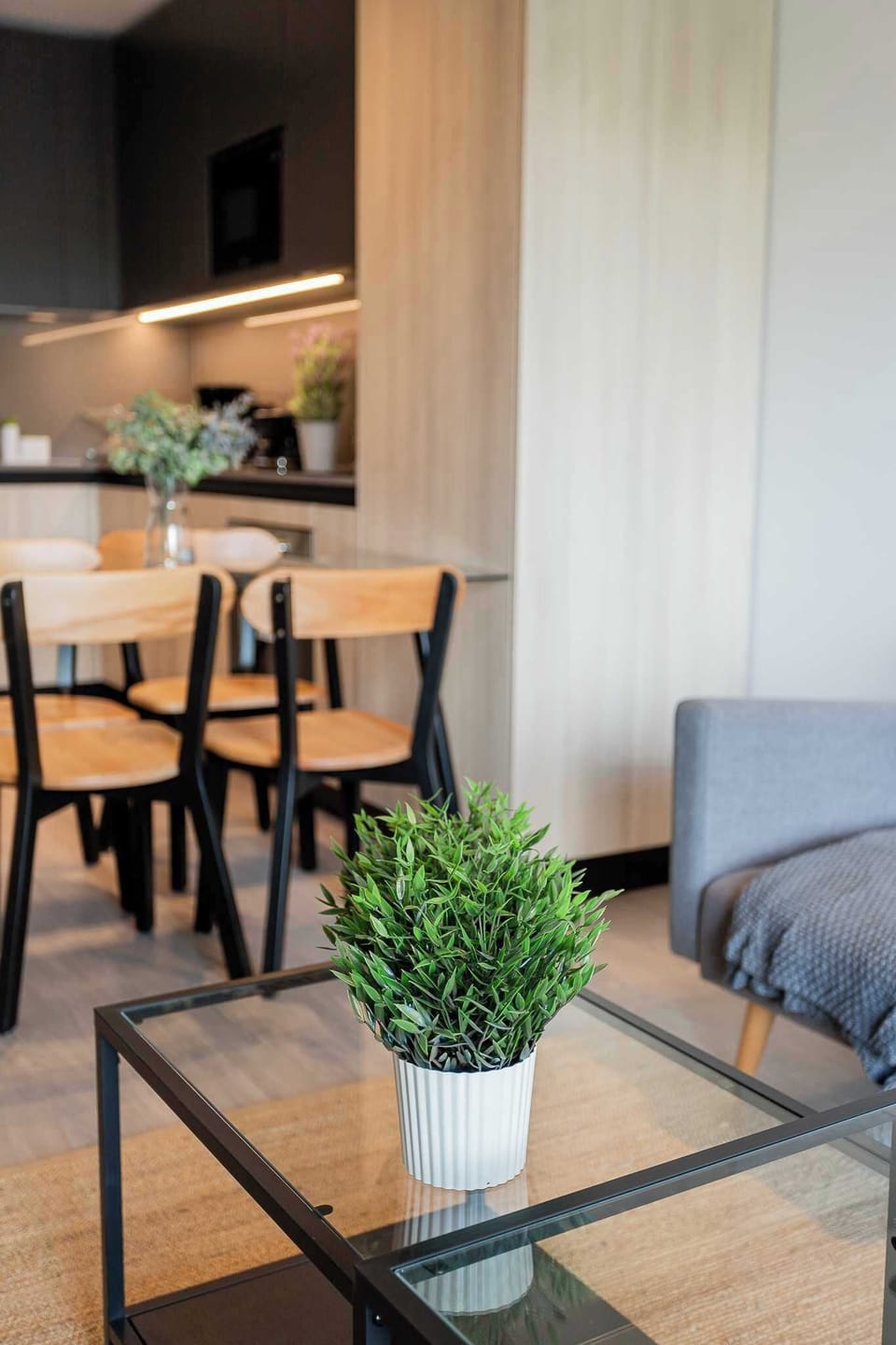 Experience modern comfort in this stylish living space, featuring a cozy dining area and elegant decor for a relaxing getaway.