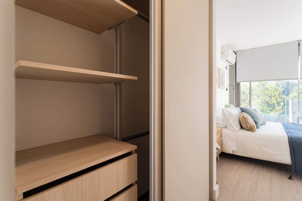Bright and cozy bedroom featuring a comfortable bed and ample storage, perfect for a relaxing getaway.