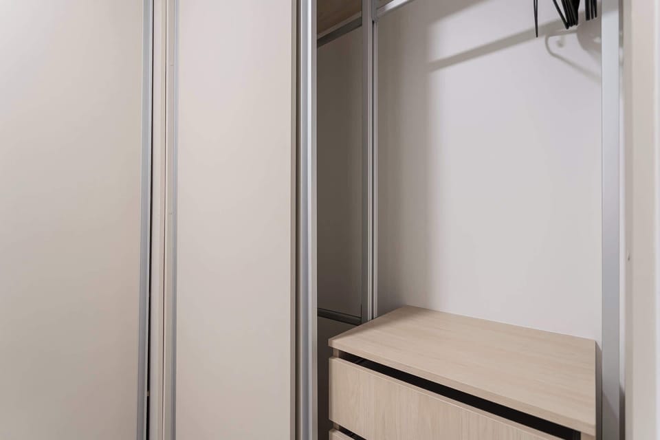 Spacious closet with ample storage and sleek sliding doors for a clutter-free stay.