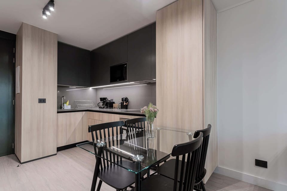 Stylish modern kitchen with sleek design and cozy dining area, perfect for intimate meals.