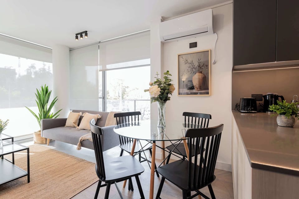 Bright and modern living space with chic decor and ample natural light, perfect for relaxation and dining.