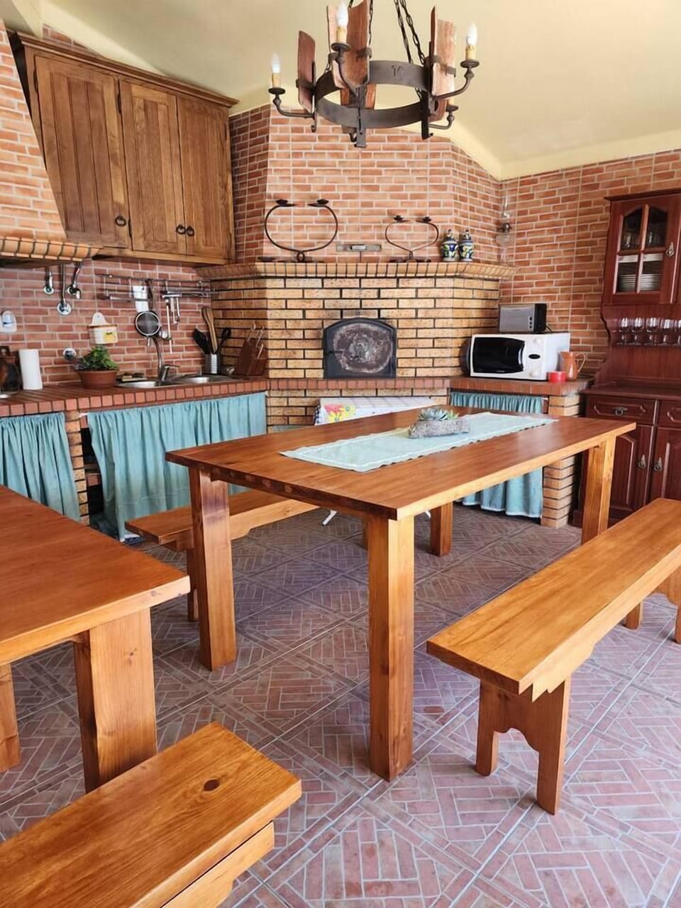 outdoor kitchen features a bread oven, barbeque, and stove. 