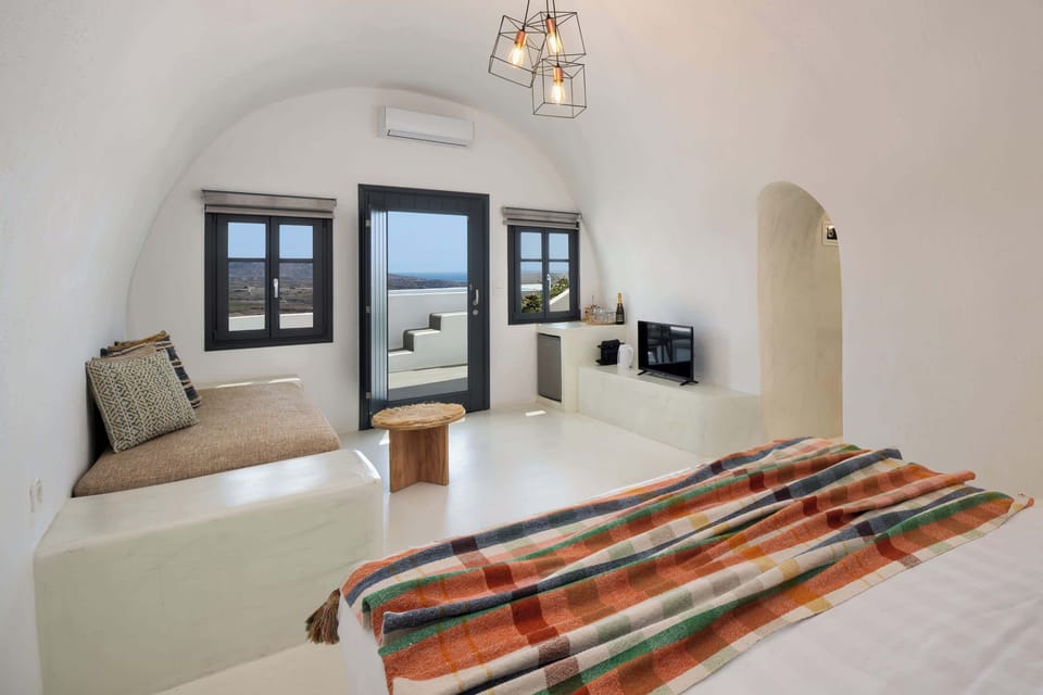 Traditional Cycladic Bedroom with Double Bed
Includes seating, window light, and subtle traditional styling with handcrafted accents.