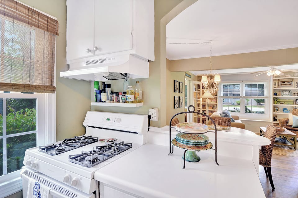 Kitchen with Gas Range and Open View - Kitchen with gas range, vent hood, counter space, and a clear view into the dining and living areas.