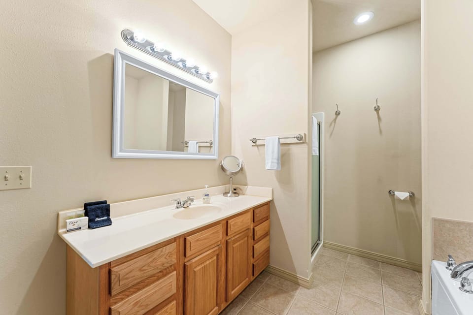 A large single vanity, shower, & soaking tub are available in the king ensuite