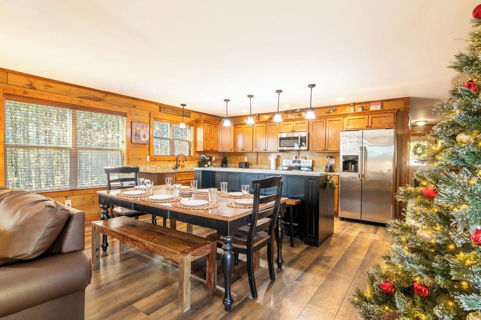 Your festive kitchen awaits with warm wood cabinets, granite counters, and a cozy dining nook perfect for holiday gatherings and memorable meals.