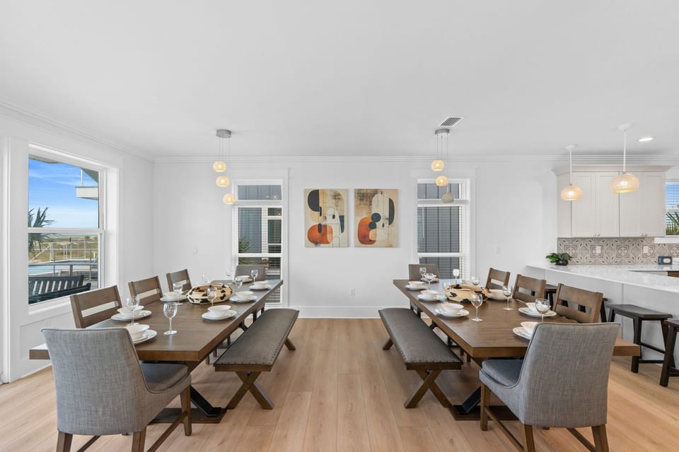Gather around spacious tables set for memorable meals, with coastal views and modern art creating a warm, inviting atmosphere for your group.