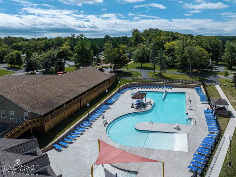 Pool Paradise: Dive into fun at our stunning community outdoor pool surrounded by lush greenery!