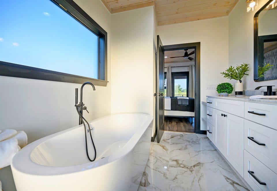 Slip into the soaking tub and let the stress melt away, surrounded by serene light and natural textures that make you feel right at home.