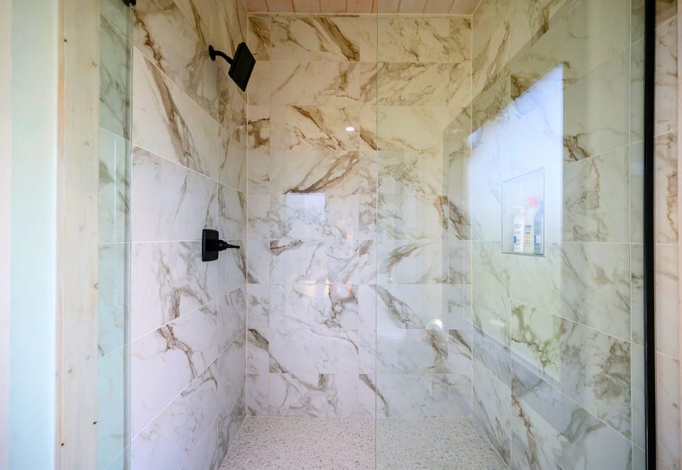 This spacious walk-in shower, wrapped in beautiful tile and glass, is a refreshing and luxurious way to start or end your day.