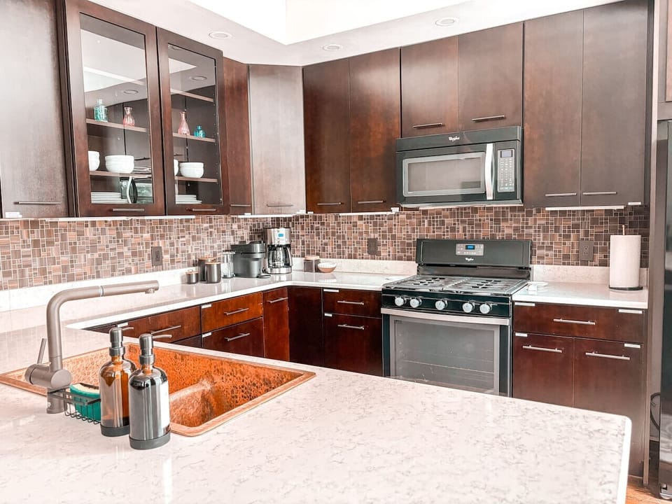 Kitchen stocked with: drip coffee, Nespresso, coffee grounds & pods, dishware, cutlery, cooking utensils, and more