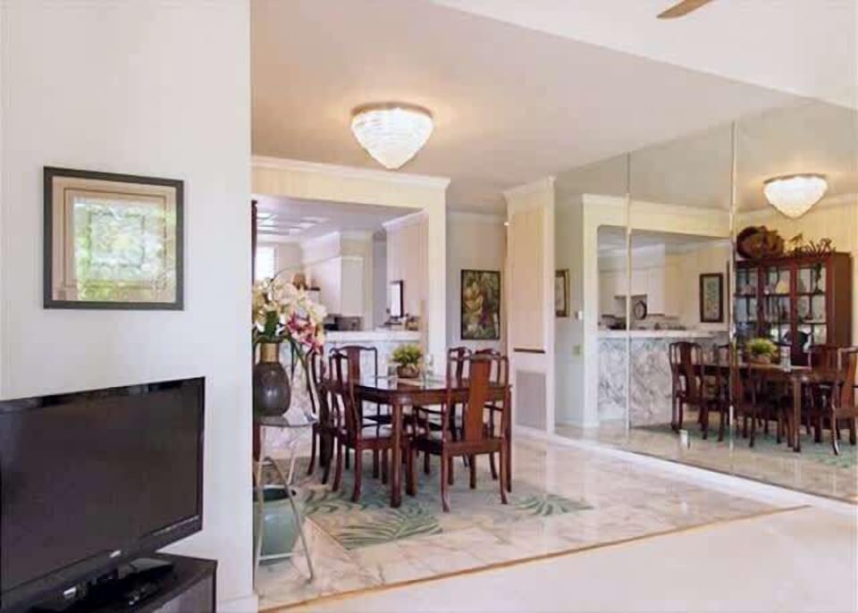 Elegant dining area flows into a well-lit living space, perfect for family dinners.
