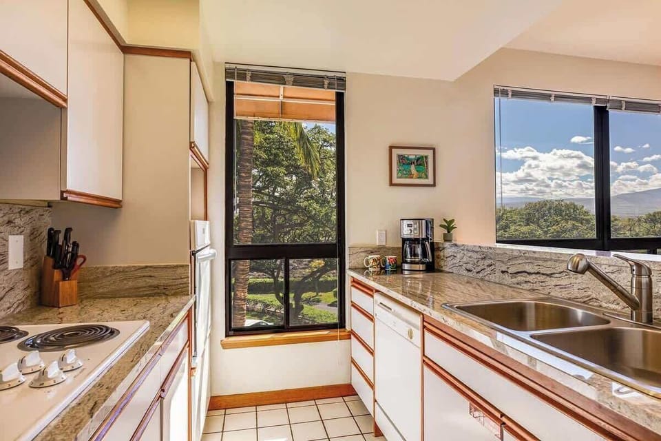 Prepare meals in this granite kitchen with full appliances and breathtaking tree and mountain views.


