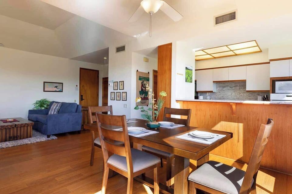 Share meals by the window in this sunlit dining space, steps from the fully equipped modern kitchen.

