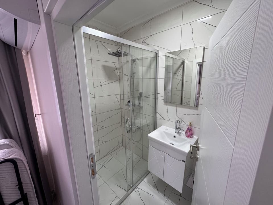 Family Room, Partial Sea View | Bathroom | Hair dryer, towels, soap, shampoo