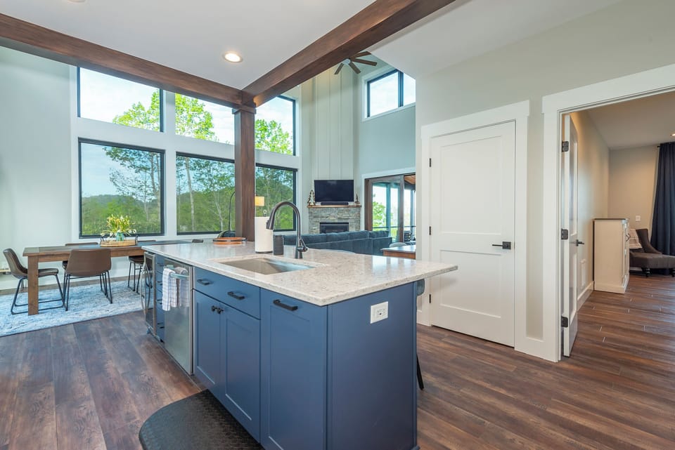 Kitchen with island seating for 4, wet bar, and coffee station with a drip-style coffee maker and Keurig