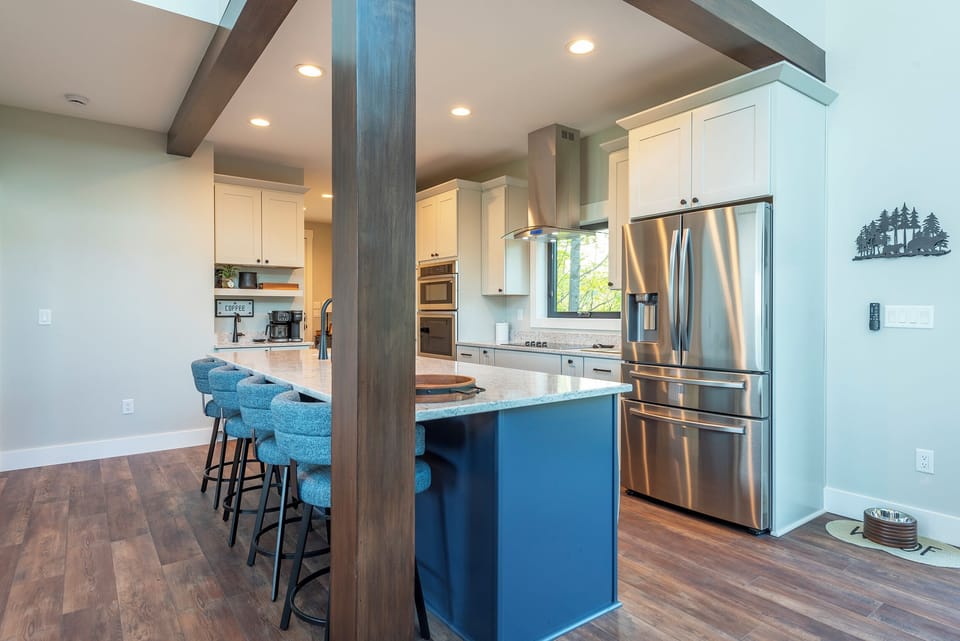 Kitchen with island seating for 4, wet bar, and coffee station with a drip-style coffee maker and Keurig