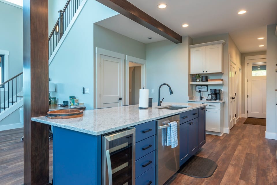 Kitchen with island seating for 4, wet bar, and coffee station with a drip-style coffee maker and Keurig