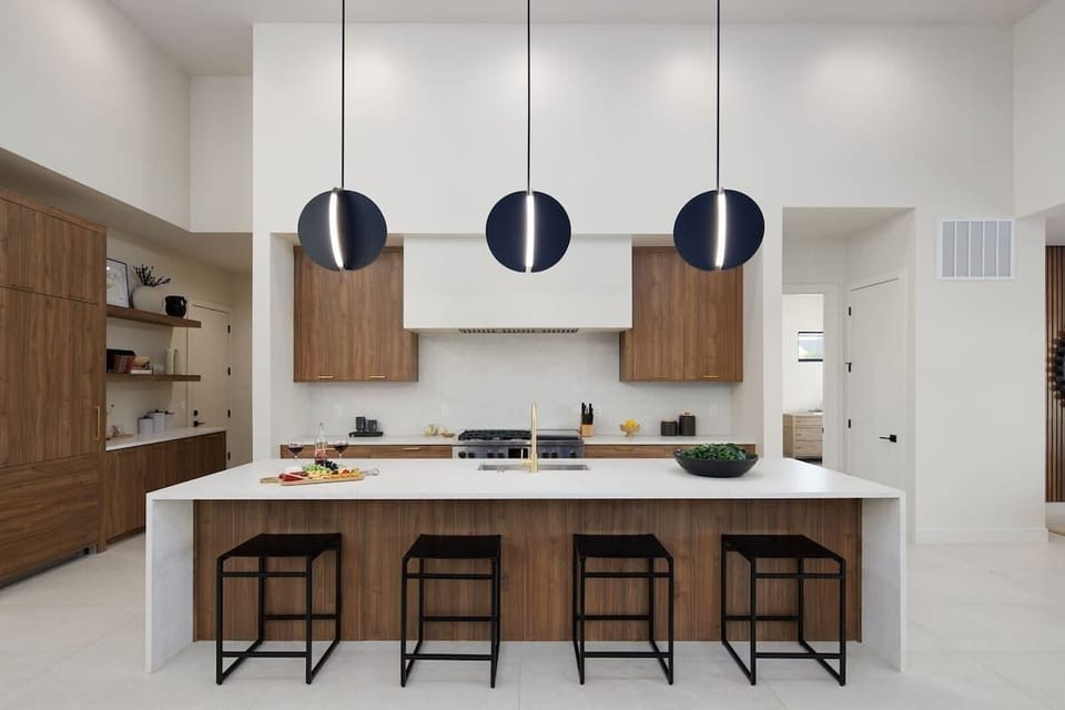 Unit 1: Fully equipped chefs kitchen featuring a colossal kitchen island offering an abundance of counter space with bar seating, high-end stainless steel appliances and stocked with all culinary essentials.