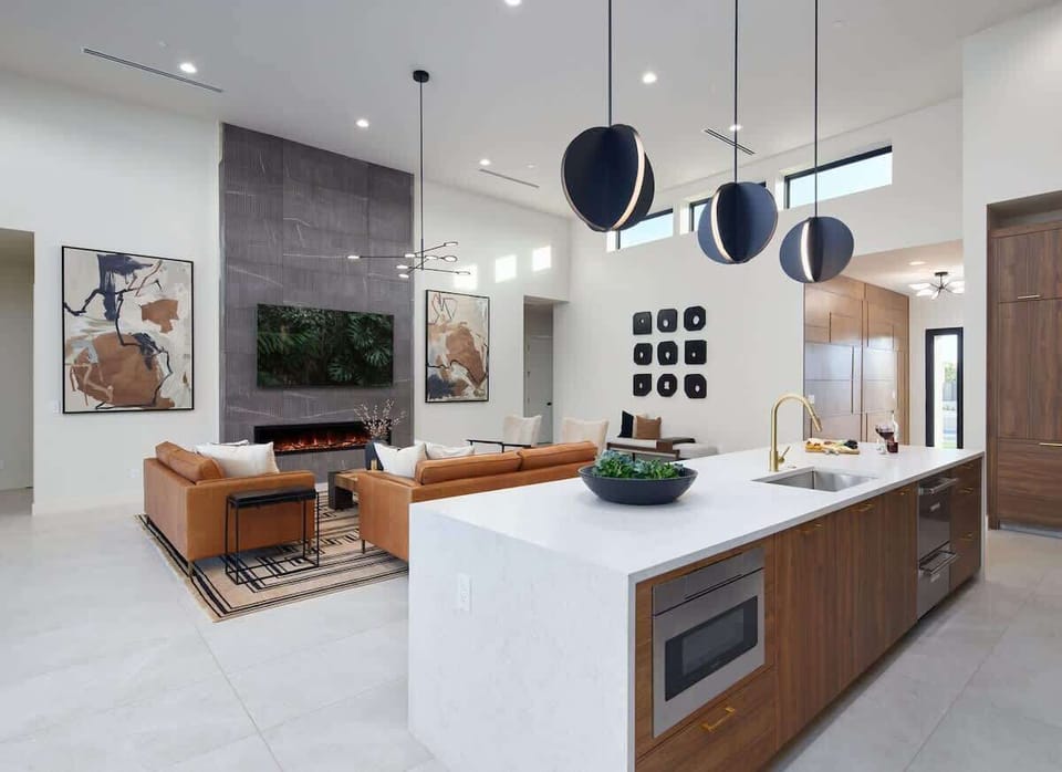 Unit 1: Fully equipped chefs kitchen featuring a colossal kitchen island offering an abundance of counter space with bar seating, high-end stainless steel appliances and stocked with all culinary essentials.