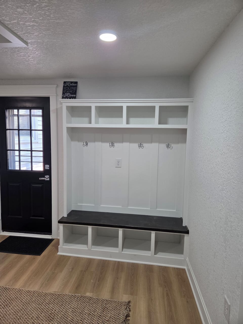 Spacious cubbies offer easy storage for shoes, coats, bags and luggage