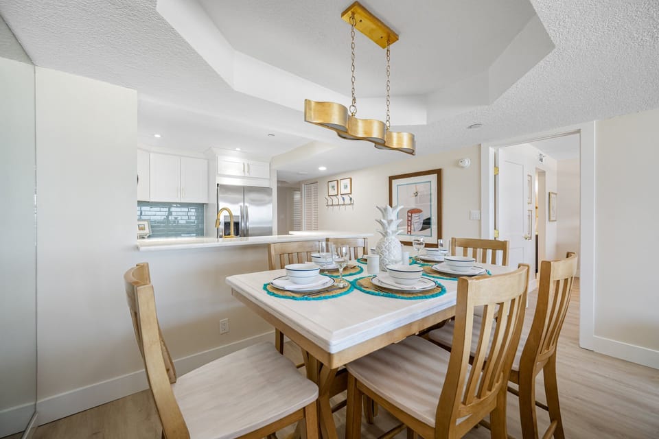 Stylish dining setup with direct access to kitchen and living room.