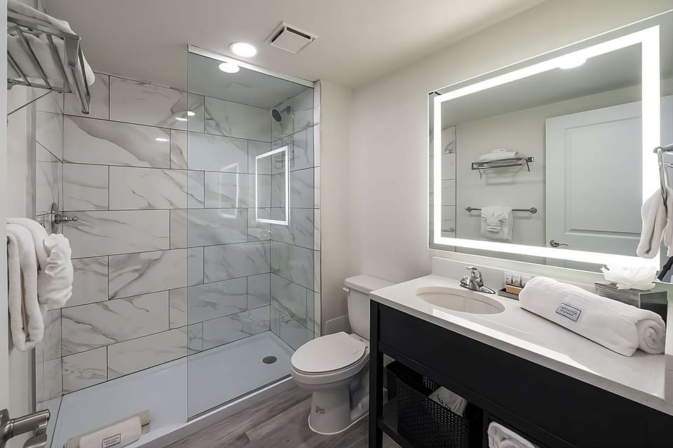 Refresh easily in a spotless bath with glass walk-in shower.