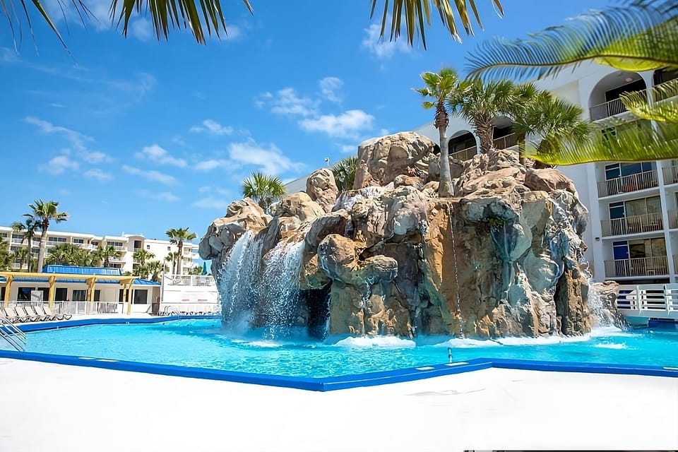 Soak beneath the dramatic waterfall for instant vacation vibes.