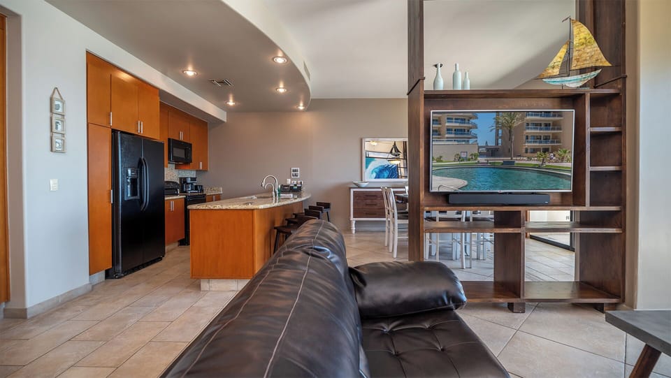 The main room separates the living groom from the dining room with a unique room divider with TV