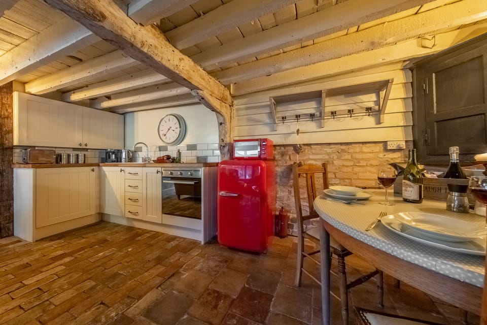 Ground floor: Kitchen area with dining table and chairs