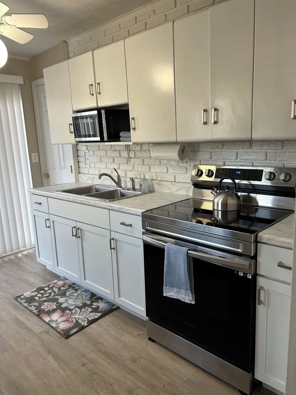Microwave, smooth top stove, slider out to deck and backyard